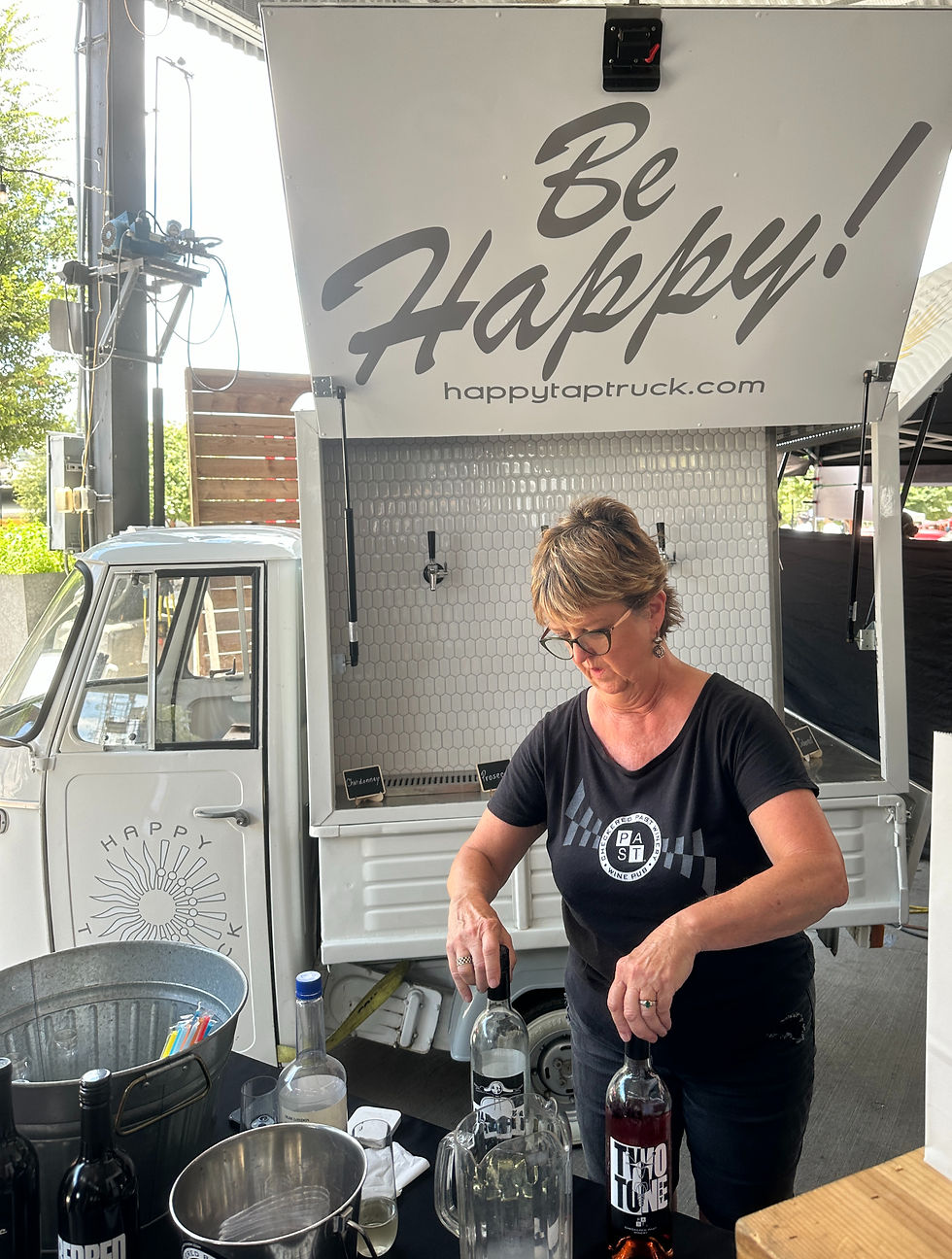 White little truck with beer taps with a sign above that says Be Happy