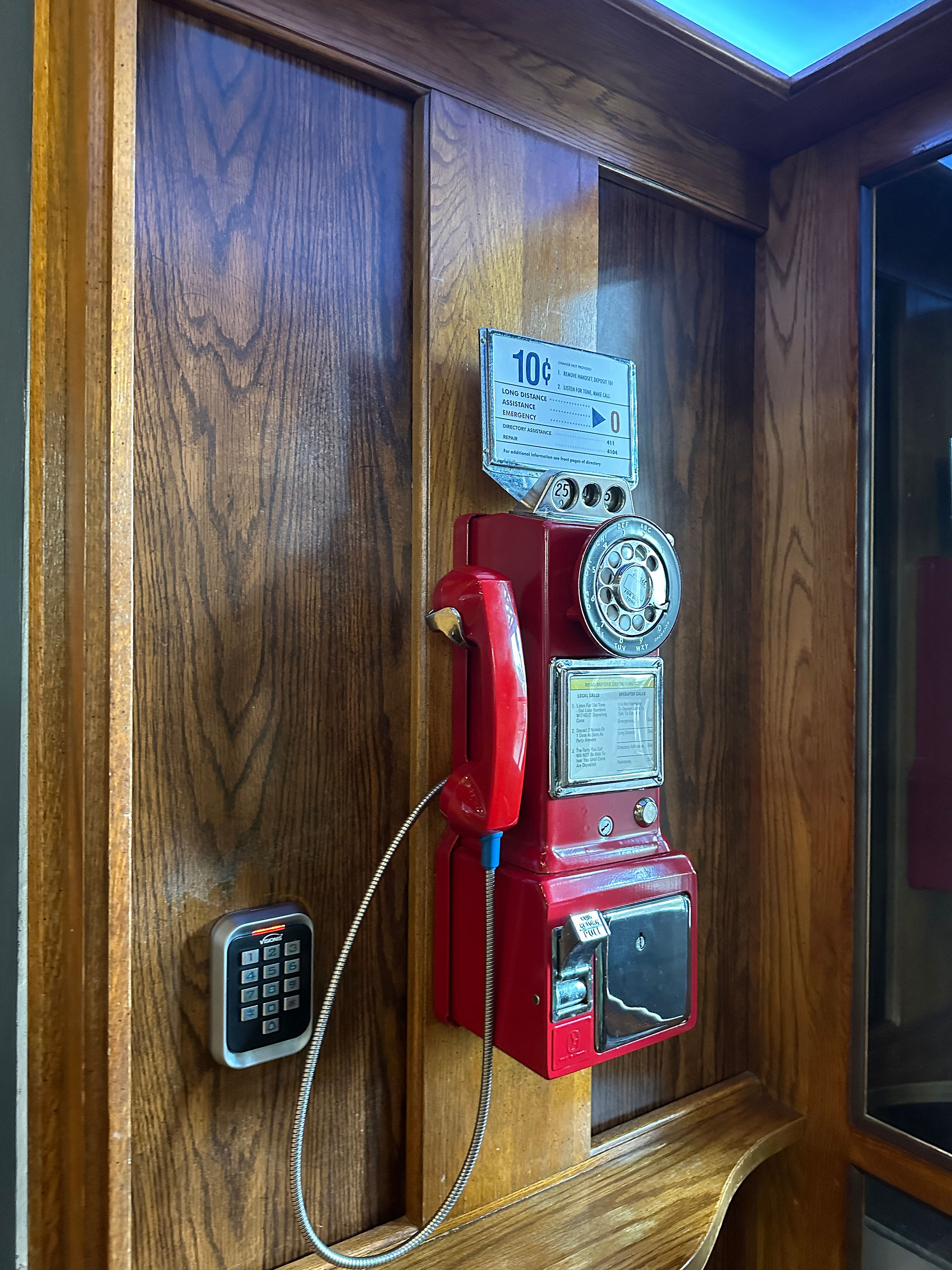 Phone booth with a red pay phone
