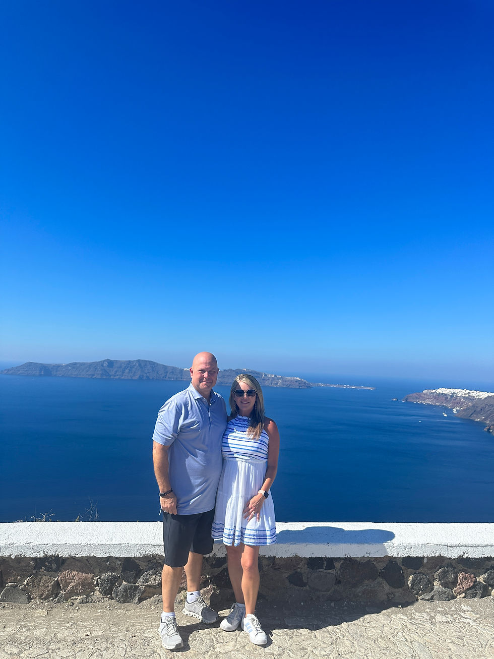 Man and woman standing together with ocean view in the distance