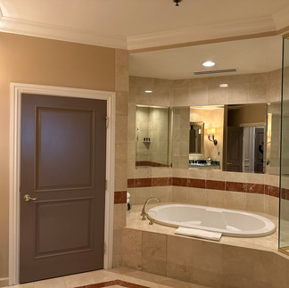 Large bathroom with tub at hotel suite