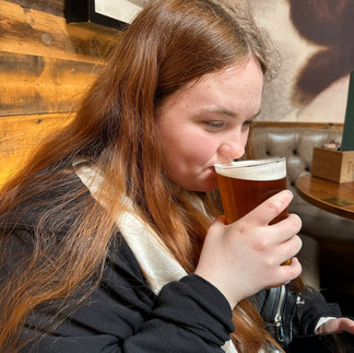 Girl sipping on a beer