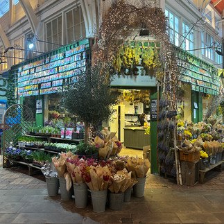 Flower shop entrance with fresh flowers bouquets inside the Covered Market