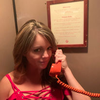 Girl in the red phonebooth entrance to PDT in NYC