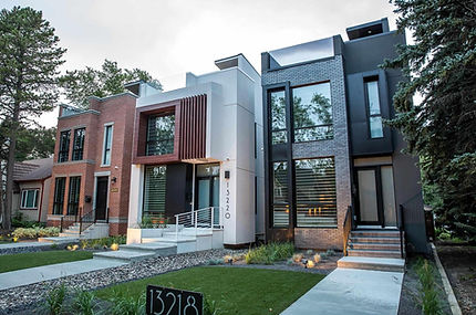 Modern architectural design featuring a prominent front facade, large windows and concrete steps with classic railings