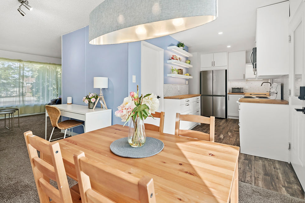 A bright and decluttered living room and kitchen in Edmonton, prepared for a real estate listing.
