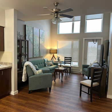 A brightly lit, safely arranged senior living suite living room in Edmonton, showcasing smart floor planning.