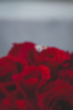 engagement ring on a red rose bouquet; valentine's day proposal ideas