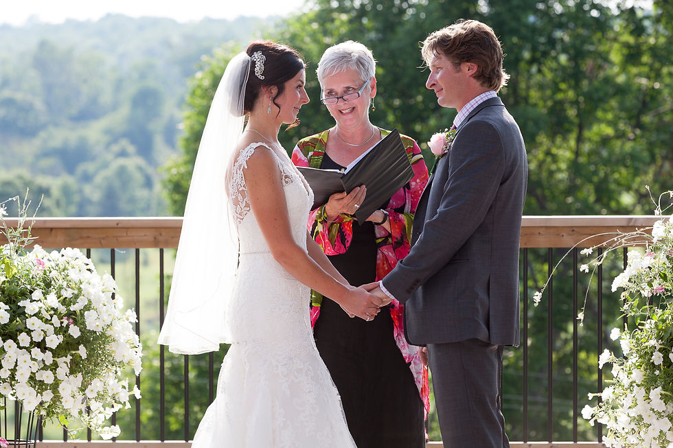 Late-afternoon wedding ceremony captured in natural light as the sun sets during vows, creating a quiet, timeless moment.