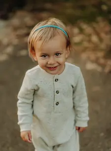 A portrait of a young boy smiling at camera.