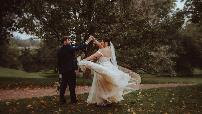 A bride is twirled around by her groom before their wedding in Ottawa, Ontario.