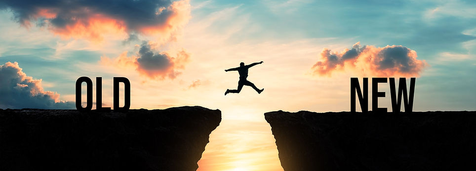 Silhouette of a person jumping from old to new over a gap between cliffs at sunset, transi