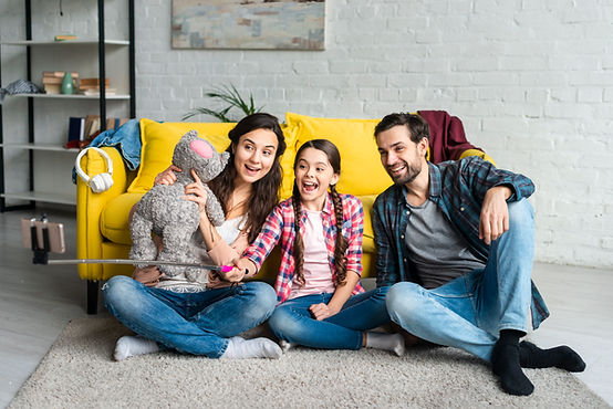happy-family-sitting-floor-taking-selfie.jpg