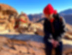 Chiara and a dromedary in the foreground, the Sinai desert in the background