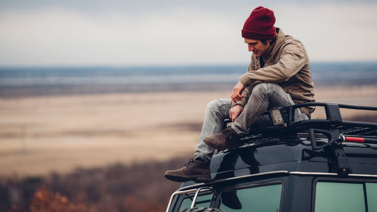 man sitting on vehicle