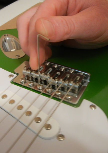 Adjusting string heights and actions on a Stratocaster.