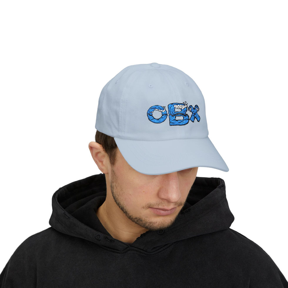 Man wearing a light blue baseball cap with the text OBX embroidered in blue waves