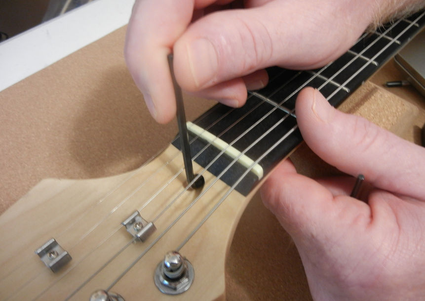Electric guitar getting a truss rod adjustment