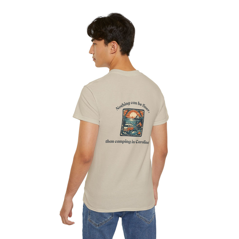 Man wearing a tan t-shirt with the text 'Nothing can be finer than camping in Carolina' and a graphic of a sunset and a camper van