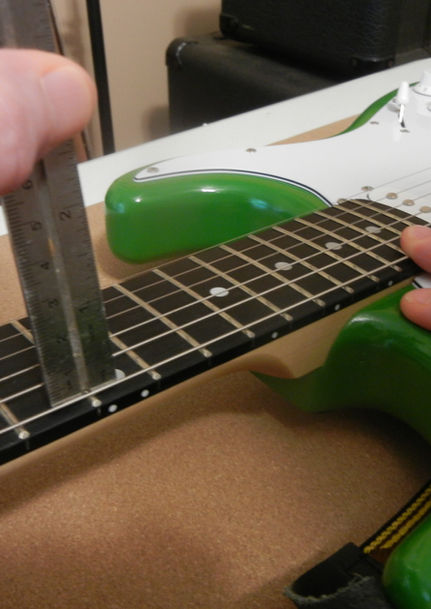 Measuring string height of a guitar