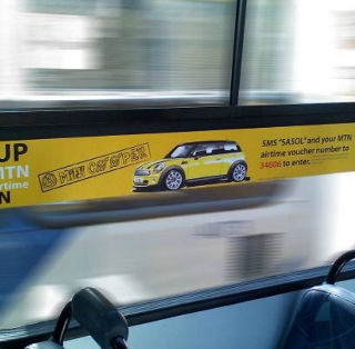 Transit advertising on a vehicle wrap for Mini Cooper.