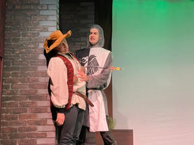 a man in a knight costume is holding an arrow