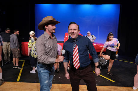 a man in a cowboy hat is holding a microphone