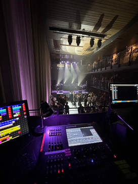 a stage with a purple light behind a monitor that says ' mixer ' on it