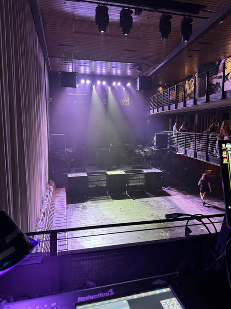 an empty stage with a purple light shining on it