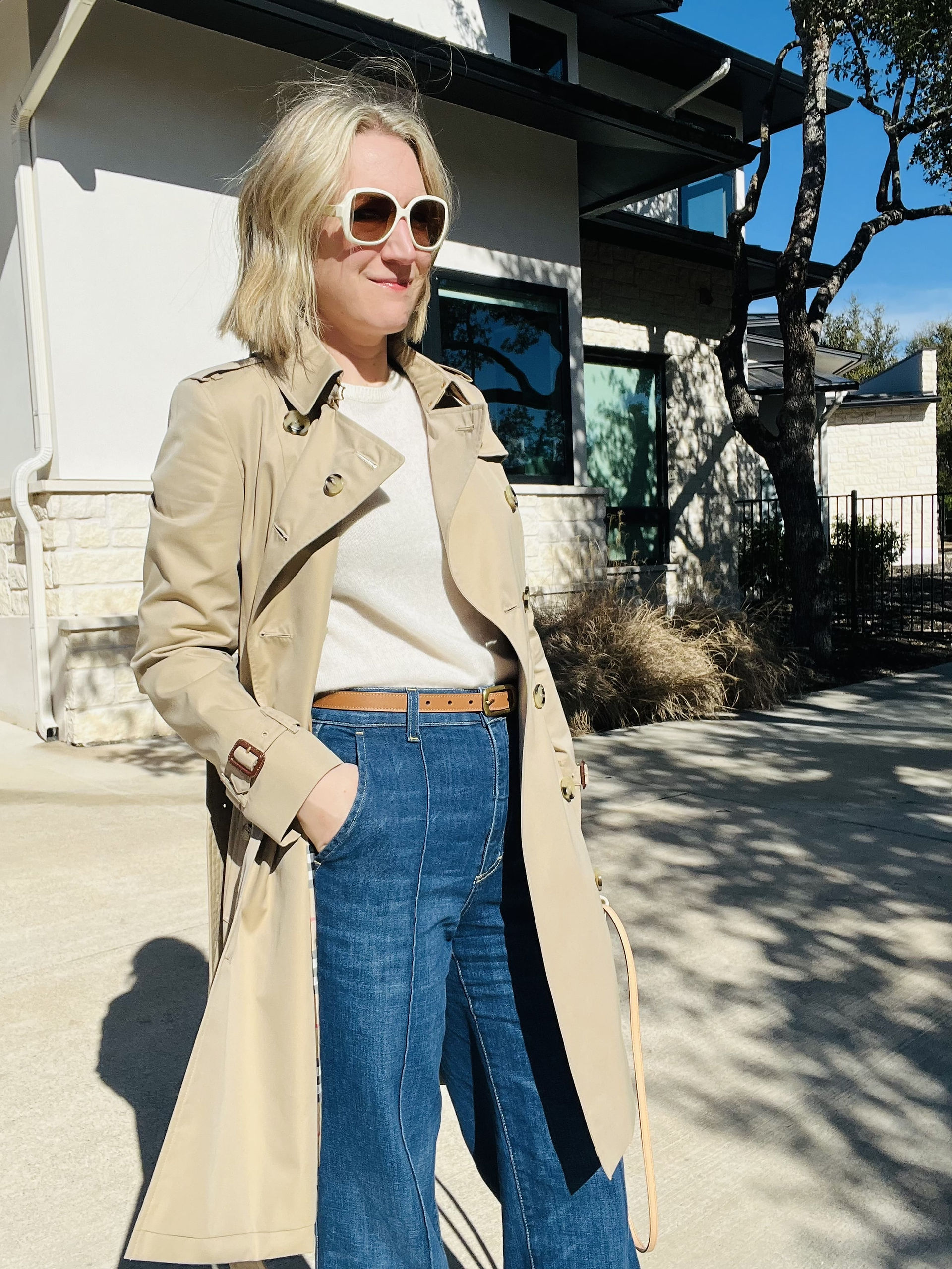 Austin personal stylist Natalie, owner of Closet Curator, styling trench styled open with jeans and sweater