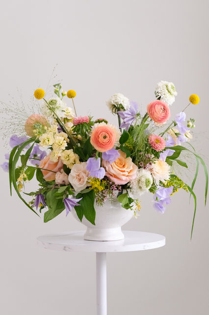 Lush pastel floral arrangement in white vase