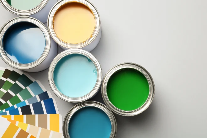 7 Factors that Affect the Cost of Interior Painting 3 Paint cans and color palette on white background, top view