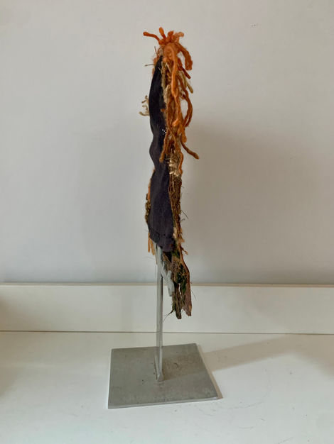 Palm tree treated with textile techniques such as loom-woven tapestry, embroidery, darning, sewing, and acrylic painting.