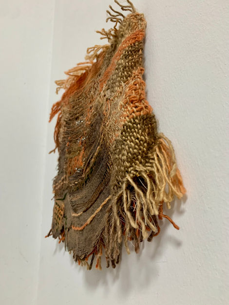 Palm tree treated with textile techniques such as loom-woven tapestry, embroidery, darning, sewing, and acrylic painting.