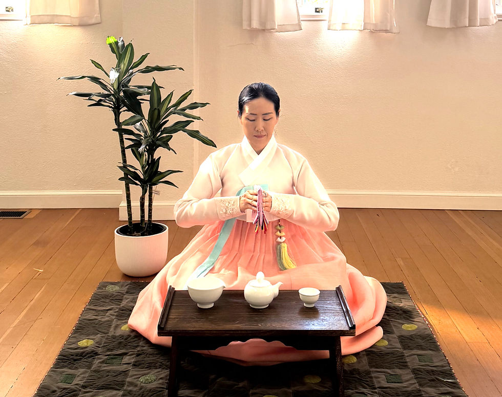 Korean tea ceremony with Yuna Lee wearing traditional hanbok and holding a tea cup in Santa Barbara