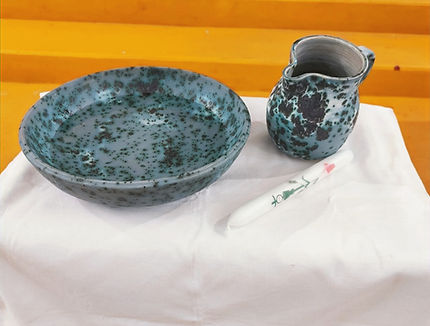 Baptism bowl and jug on table