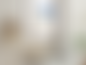 Minimalist and tranquil, this modern living space features a stylish abstract art piece in shades of gold and blue, beautifully complemented by neutral furnishings and elegant decor elements.