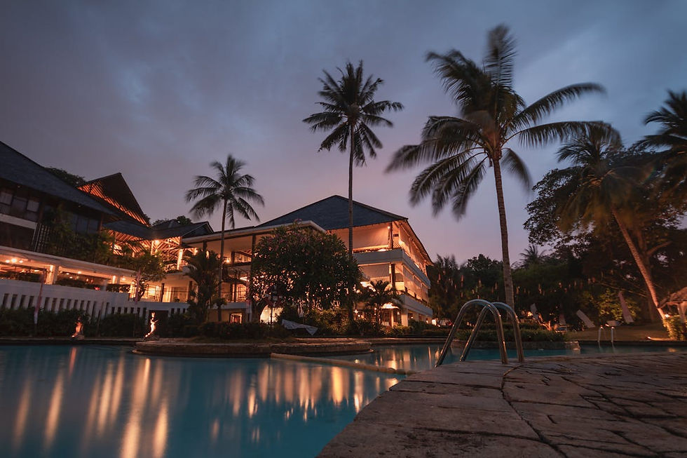 Boutique hotel exterior at dusk with warm lit windows — illustrating how AI engines describe a property's character but credit competitors with cleaner schema data