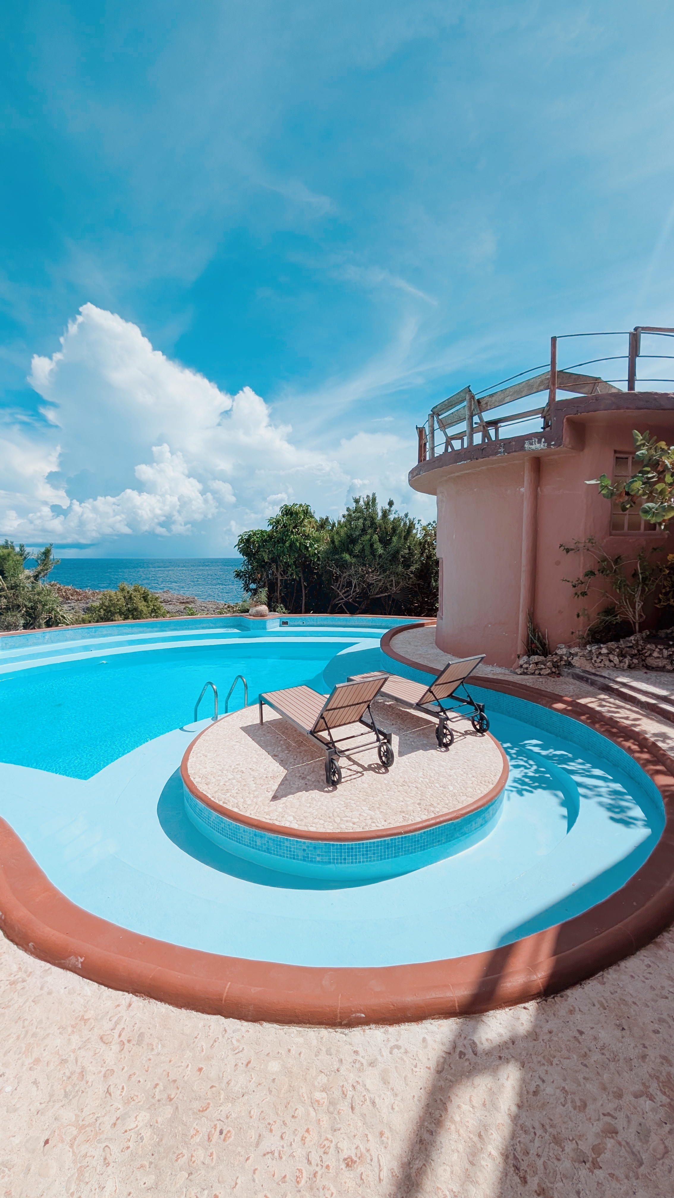 Open air restaurant at Great Huts eco resort with wooden tables and sea view