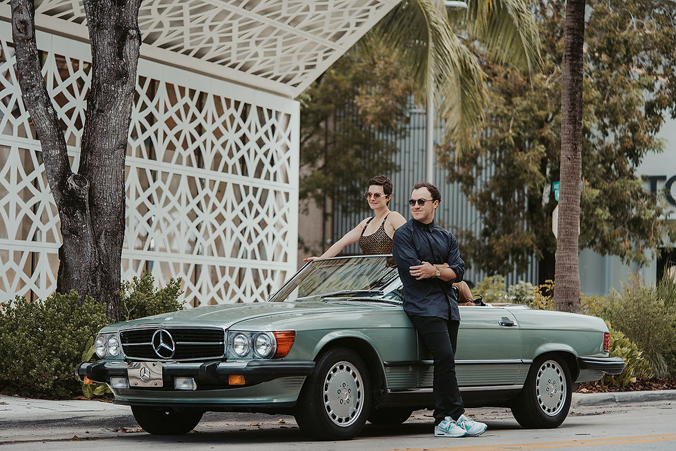 Fun loving man and woman married at Miami Design district with rented vintage color green car brand Mercedes Benz