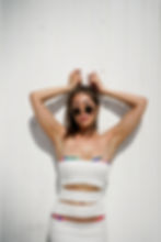Young woman wearing white dress and bikini fashion photoshoot at miami beach fl., ocean drive