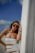 Young woman wearing white dress and bikini fashion photoshoot at miami beach fl., ocean drive