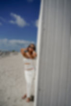 Young woman wearing white dress and bikini fashion photoshoot at miami beach fl., ocean drive