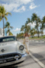 Young woman wearing white dress and bikini fashion photoshoot at miami beach fl., ocean drive