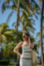 Young woman wearing white dress and bikini fashion photoshoot at miami beach fl., ocean drive
