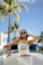 Young woman wearing white dress and bikini fashion photoshoot at miami beach fl., ocean drive