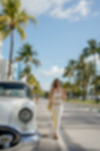Young woman wearing white dress and bikini fashion photoshoot at miami beach fl., ocean drive