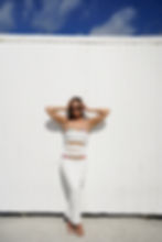 Young woman wearing white dress and bikini fashion photoshoot at miami beach fl., ocean drive