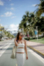 Young woman wearing white dress and bikini fashion photoshoot at miami beach fl., ocean drive