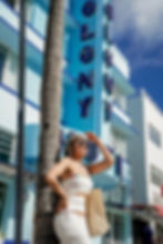 Young woman wearing white dress and bikini fashion photoshoot at miami beach fl., ocean drive