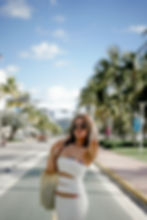Young woman wearing white dress and bikini fashion photoshoot at miami beach fl., ocean drive